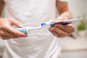 brushing with electric toothbrush to keep braces clean