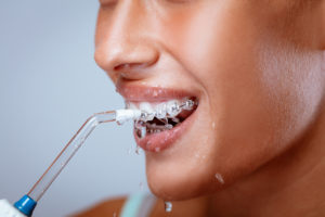 Woman using water flosser 