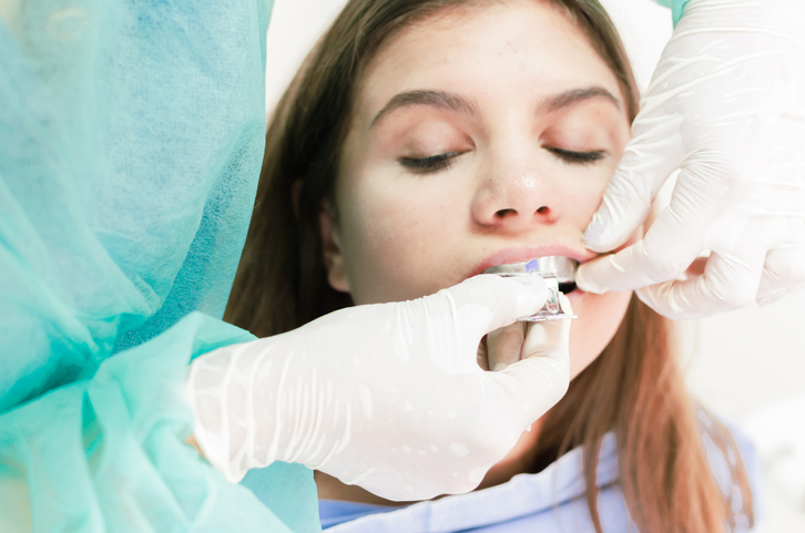 dentist installing porcelain dental bridges