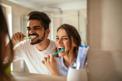 couple brushing teeth