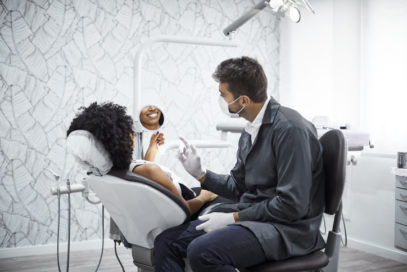 Doctor and patient talking about dental restoration procedures